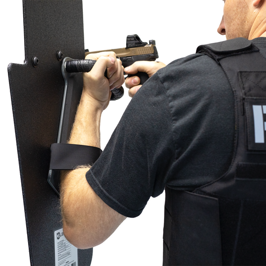 Side of man holding black 15" x 25" Caliber Armor Pistol rated Level IIIA HG2 Ballistic Shield with pivoting handle on a white background 7