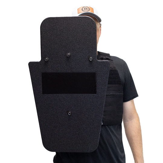 Front of black 15" x 25" Caliber Armor Pistol rated Level IIIA HG2 Ballistic Shield with pivoting handle held by a man a white background 5