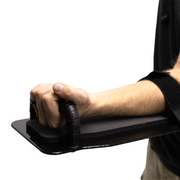 Profile view of black 8" x 17" Caliber Armor Pistol rated Level IIIA HG2 Ballistic Shield held out straight by a man grabbing the handle and using the valcro forearm strap a white background 5
