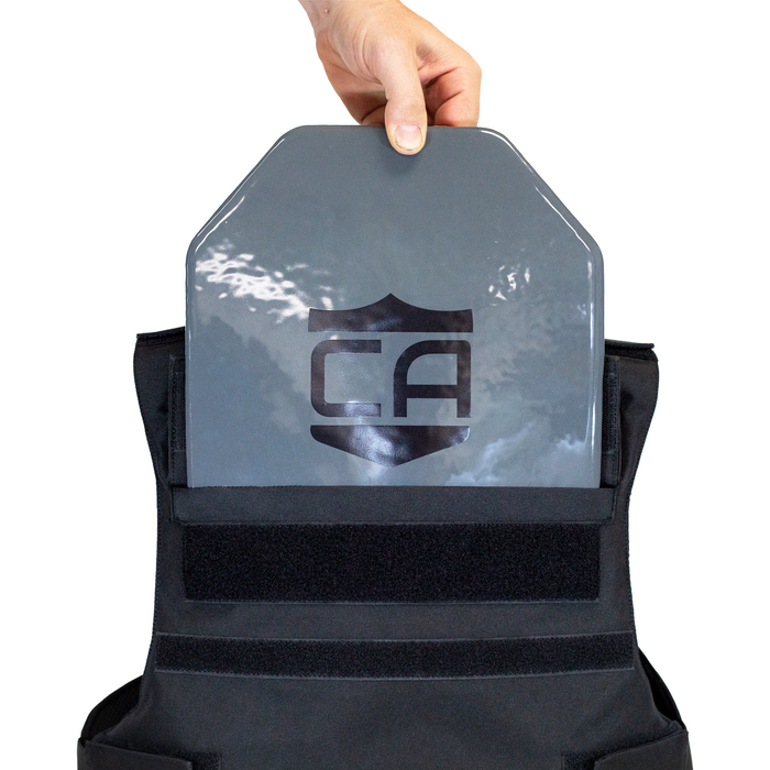 Person holding a gray armor plate showing it being top loaded into backside of patrol vest 4