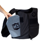 Black tactical vest with a gray armor plate being side loaded into the front of the vest 3