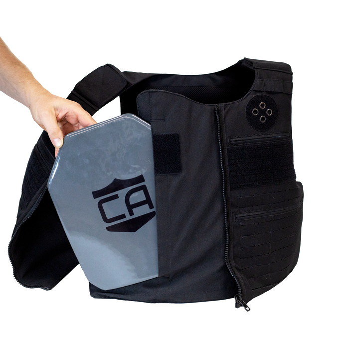 Black tactical vest with a gray armor plate being side loaded into the front of the vest 3