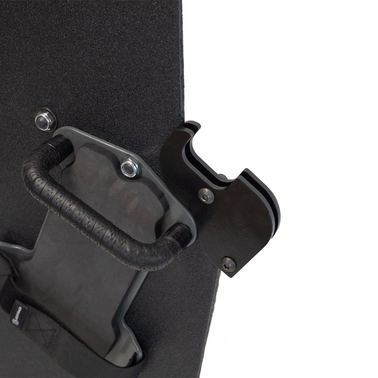Close-up of backside of a black protective shield with a handle and gun support bracket mounted on a white background 2
