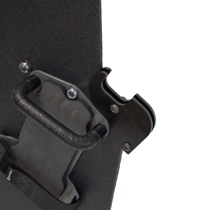 Close-up of backside of a black protective shield with a handle and gun support bracket mounted on a white background 2
