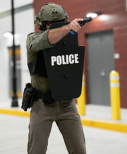 Police officer holding black 15" x 25" Caliber Armor Ballistic Shield 11