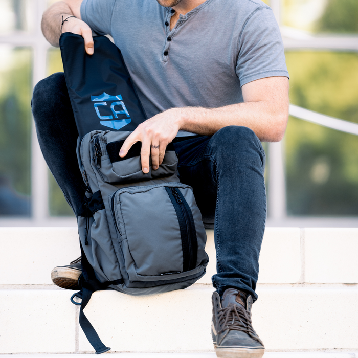 man putting soft body armor into a lynx defense backpack for everyday armored protection 0