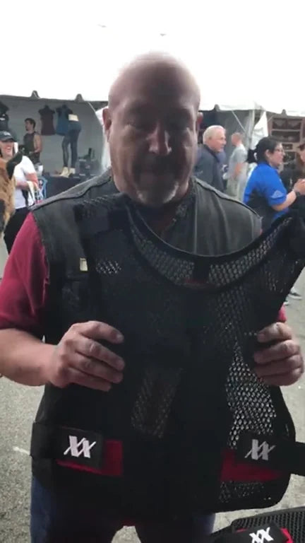 An officer holding up the Maxx-Dri Vest Elite at a 221B stand